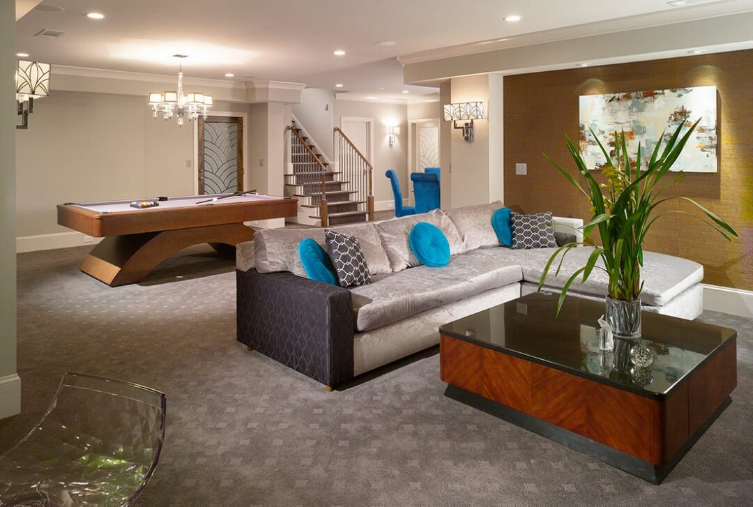 Living room showcasing a couch, coffee table, and a pool table in the Gallery in Norcross, GA