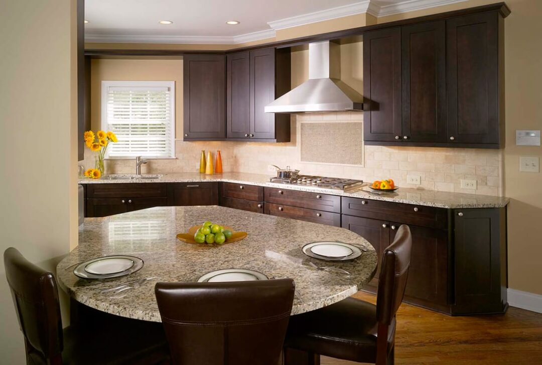 Kitchen with chocolate shaker-style dark cabinets and a round granite island table in Atlanta, GA