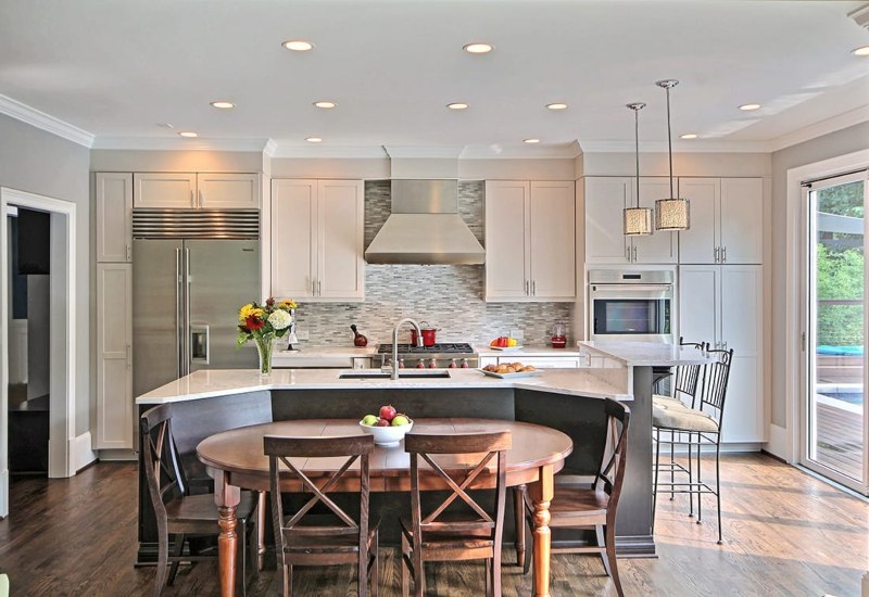 A stylish and well-designed Roswell Transitional Kitchen with a dining table and chairs in Atlanta